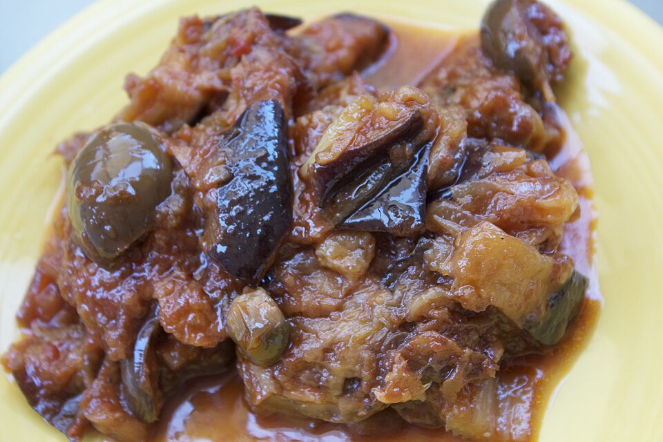 A platter of Sicilian eggplant caponata with olives and celery