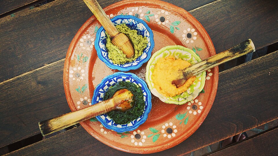Bowls of fresh tomato salsa and other salsas with tortilla chips