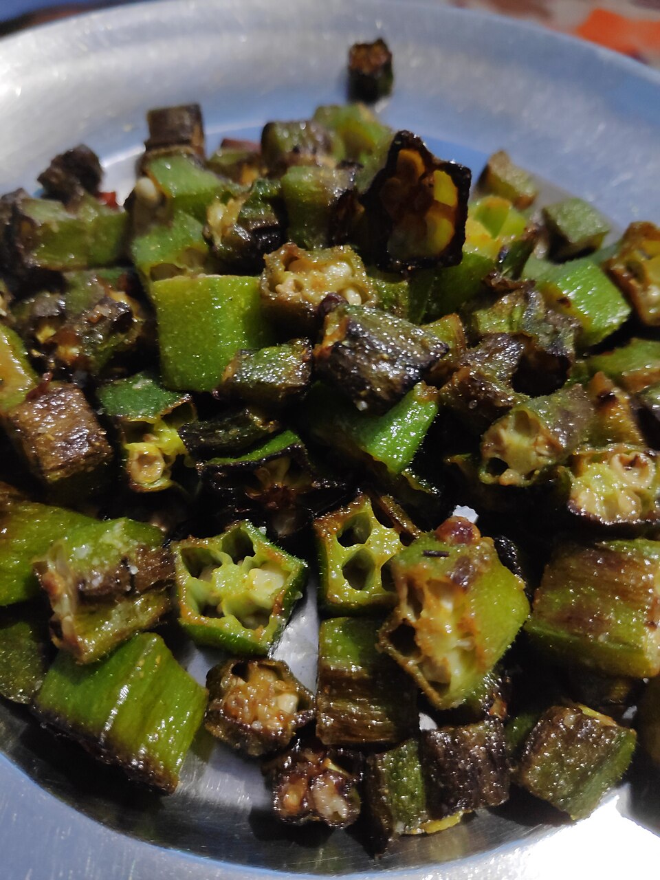 Blistered and browned okra pieces cooked with garlic and spices