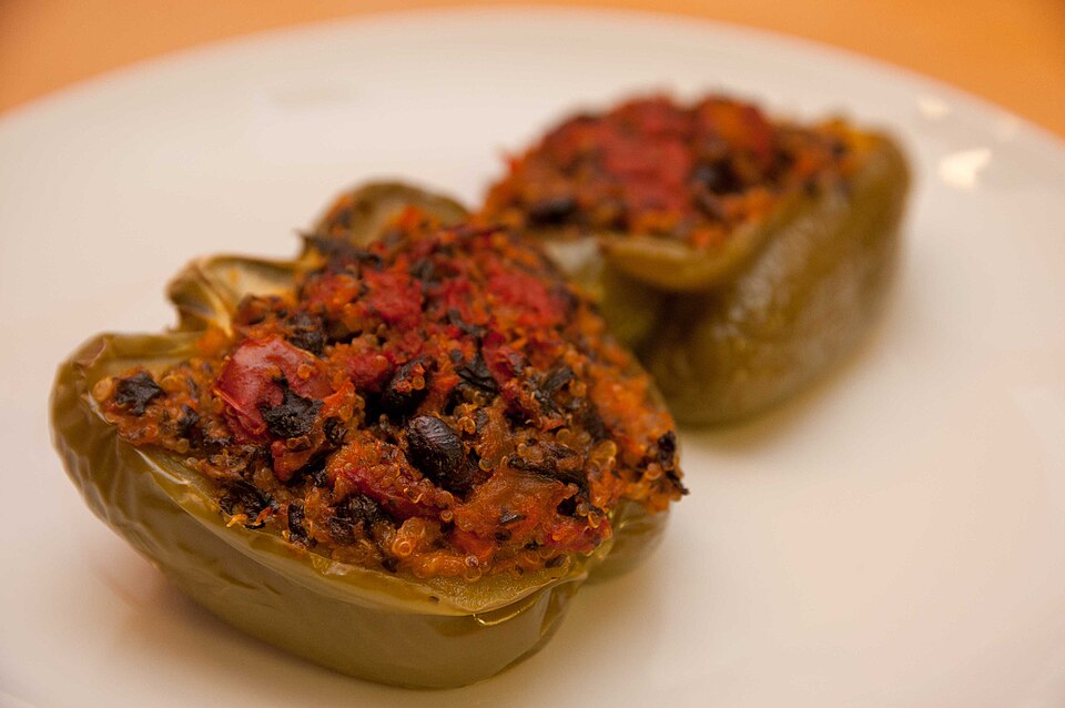 Halved sweet peppers filled with herbed quinoa and baked until golden